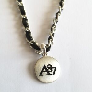 A87 necklace Silver tone black ribbon